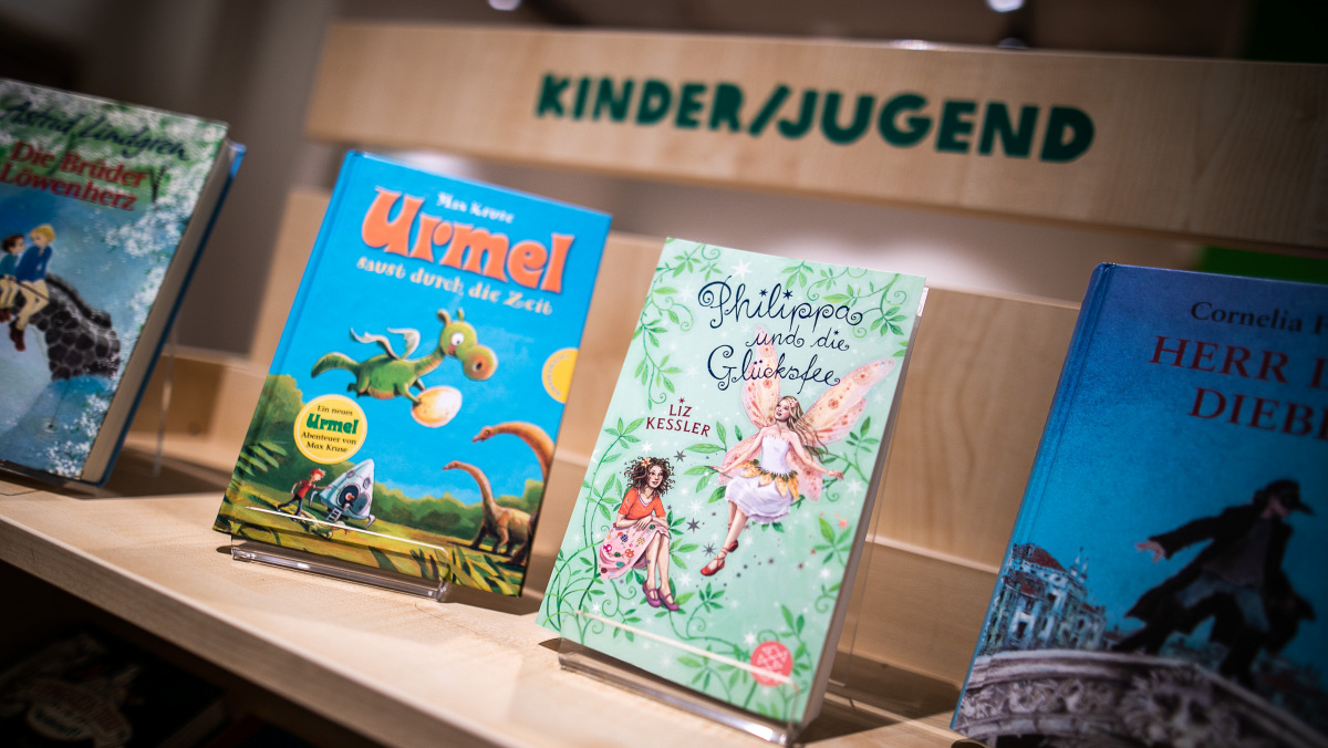 Einige Kinder- und Jugendbücher stehen im Regal des Oxfam Buchshops Berlin